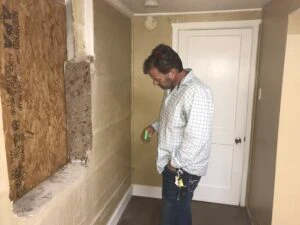 inspecting crack in wall