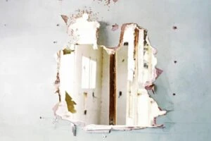 Hole busted through a drywall wall
