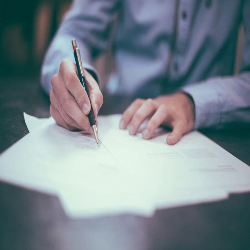 Man writing on legal documents